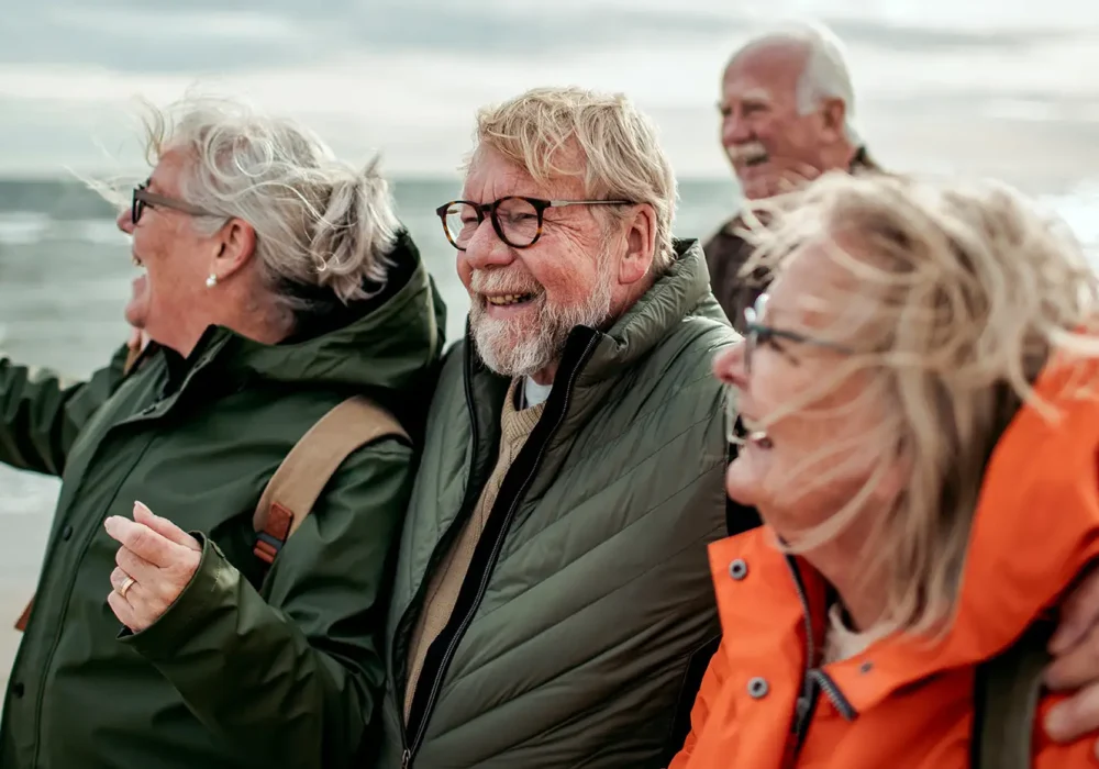 Group of happy senior friends enjoying the beach together